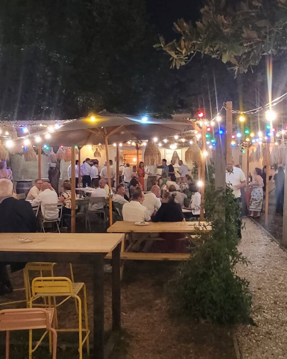 Guinguette du Bistrot un soir d'été, guirlandes lumineuses et convives attablés